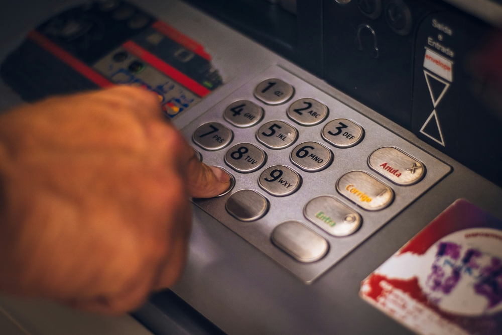 abstract image of a hand pressing buttons on an atm machine