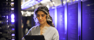technology woman working on servers