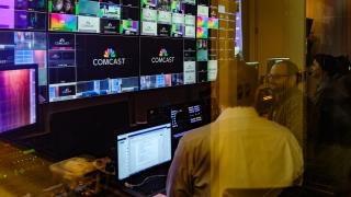 people looking at screens and editing videos