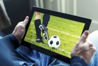 watching soccer on tablet