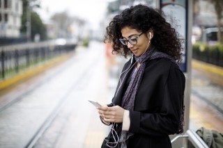 woman on phone at train station