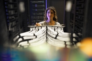 woman working on server rack