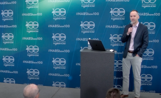 Man behind podium giving presentation
