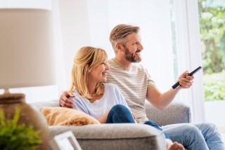 Couple watching television in their home