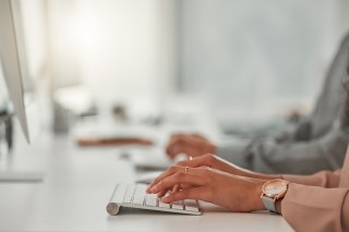 hands typing on keyboard