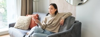 woman couch tv remote