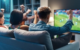 people cheering for a sports game on a tv