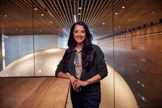 Lady smiling and leaning on table