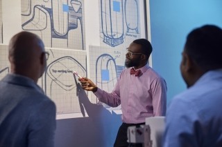 employee pointing at screen