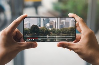 hands holding a phone that is playing a video