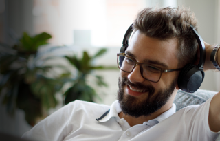 man with headphones on smiling