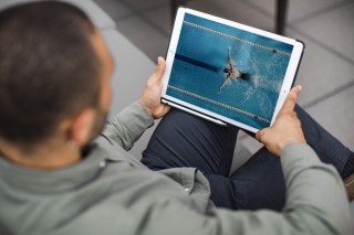technology man with tablet over the shoulder