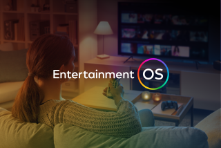 Entertainment OS logo over woman pointing remote at a tv with a rainbow overlay