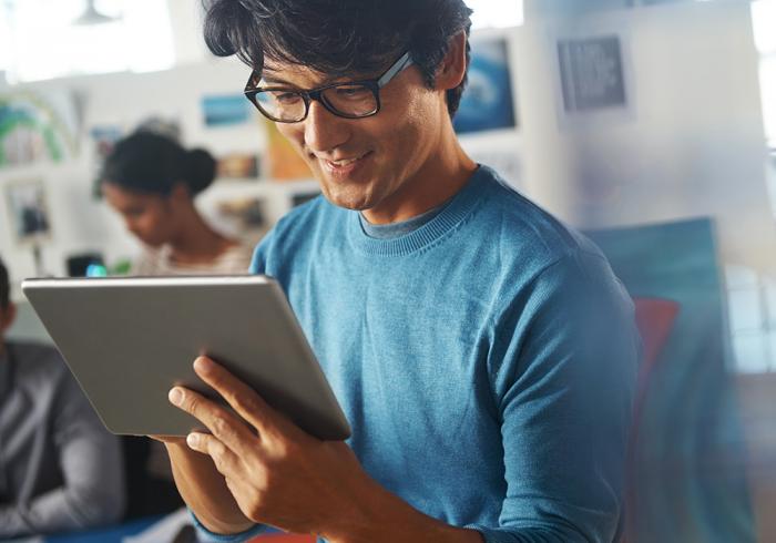 man with tablet in a blue shirt