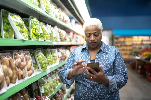 Person in grocery store aisle on mobile phone