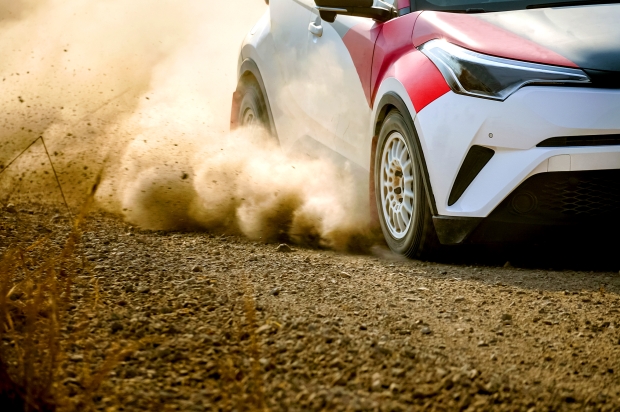 rally car racing through dirt