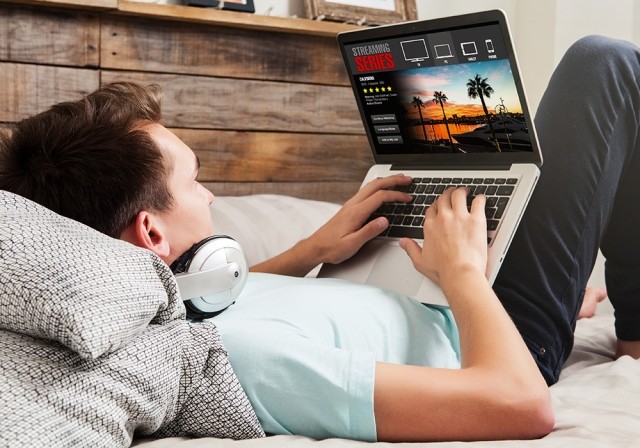 man lying down with laptop