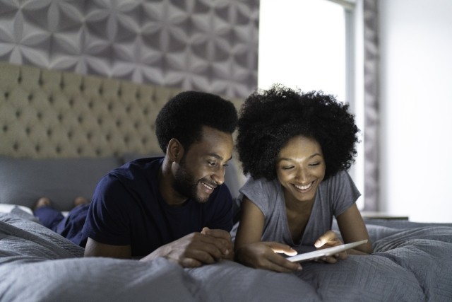 Couple in bed with tablet