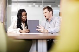 business people looking at tablet