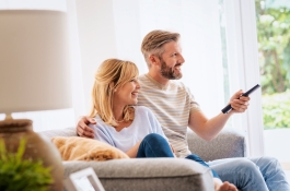 Couple watching television in their home