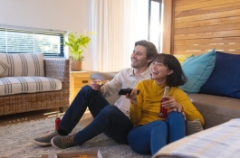 Couple eating food watching tv