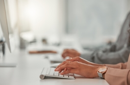 hands typing on keyboard