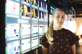 woman with many screen behind her