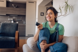 woman with remote on couch