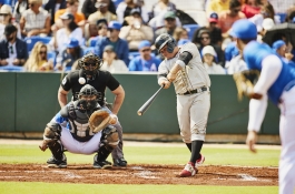 a baseball batter about to hit a ball 