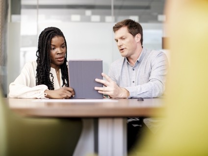 business people looking at tablet