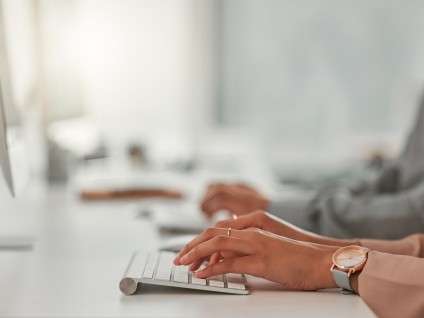 hands typing on keyboard
