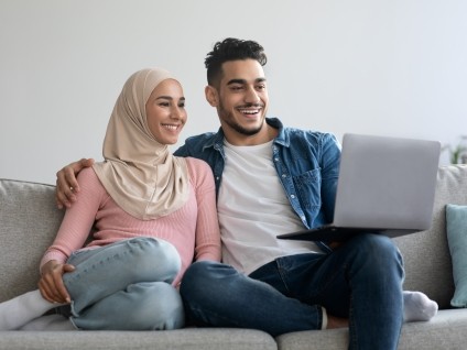 people couple watching laptop