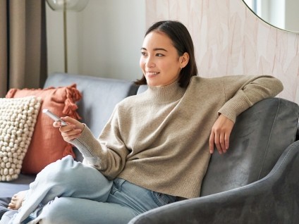 woman couch tv remote